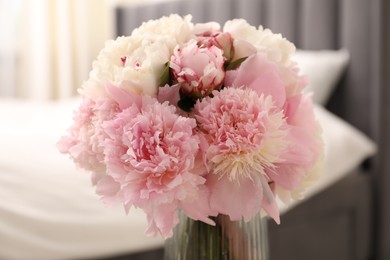 Photo of Bouquet of beautiful peonies in vase indoors, closeup