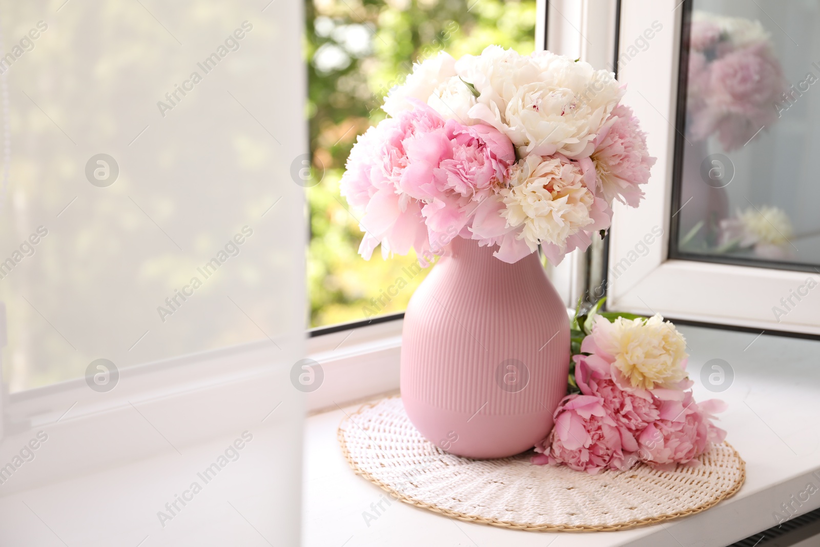 Beautiful peonies in vase on windowsill indoors Photo of Beautiful peonies in vase on windowsill indoors