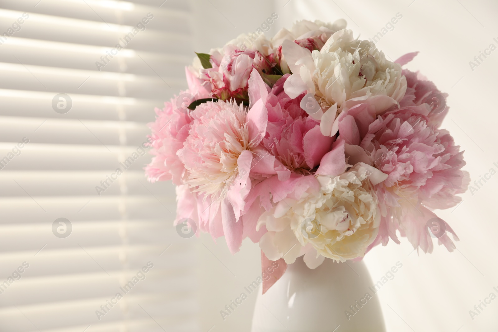 Bouquet of beautiful peonies in vase indoors, closeup. Space for text Photo of Bouquet of beautiful peonies in vase indoors, closeup. Space for text