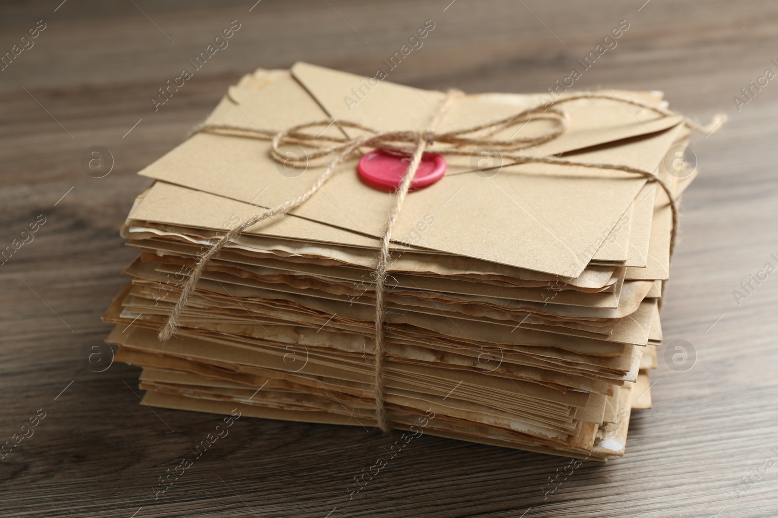 Stack of love letters on wooden table, closeup Photo of Stack of love letters on wooden table, closeup