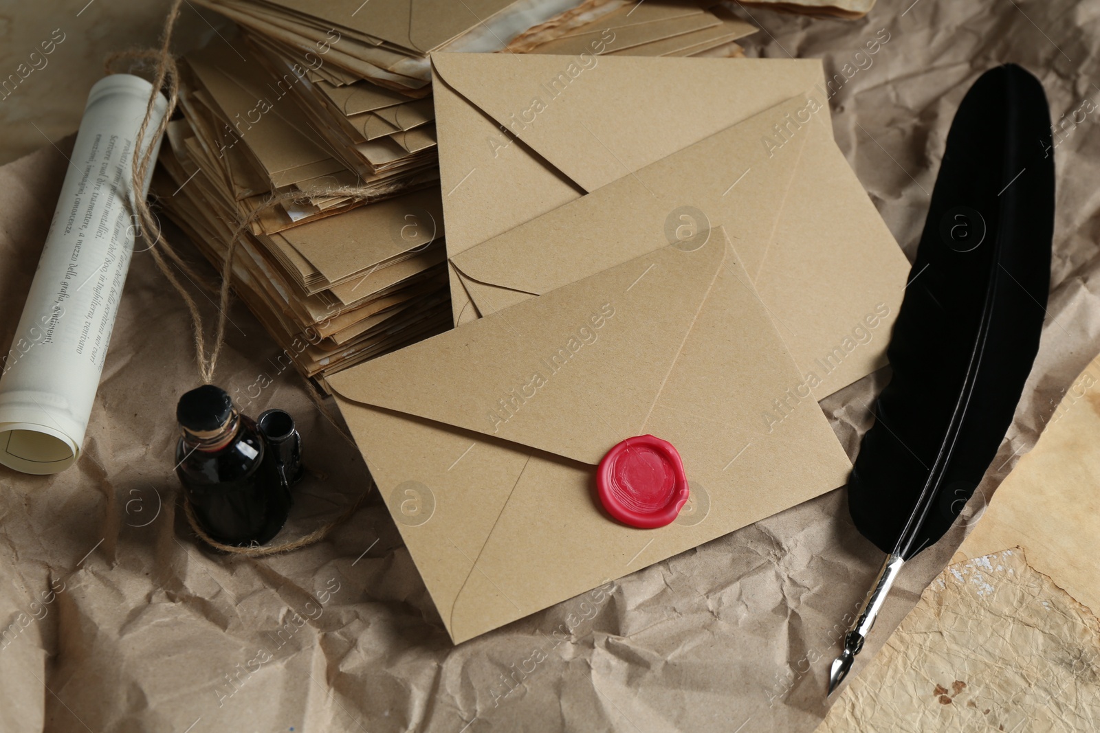 Photo of Stack of love letters, quill and ink on table