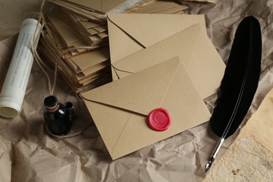 Photo of Stack of love letters, quill and ink on table