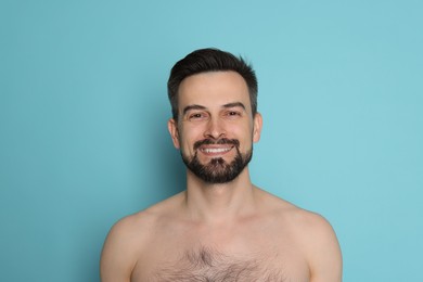 Photo of Smiling man before shaving on light blue background