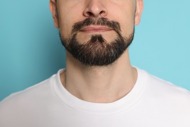 Photo of Man before shaving on light blue background, closeup