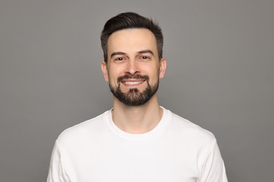 Photo of Smiling man before shaving on grey background