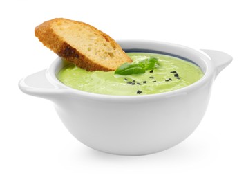 Photo of Tasty pea cream soup with basil and crouton isolated on white