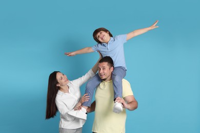 Photo of Portrait of happy family on light blue background