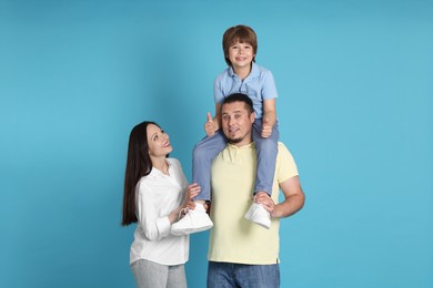 Photo of Portrait of happy family on light blue background