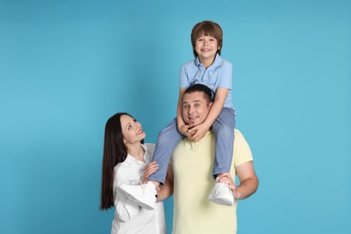 Photo of Portrait of happy family on light blue background