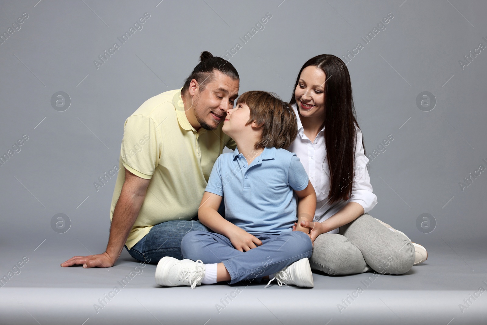 Portrait of happy family on grey background Photo of Portrait of happy family on grey background