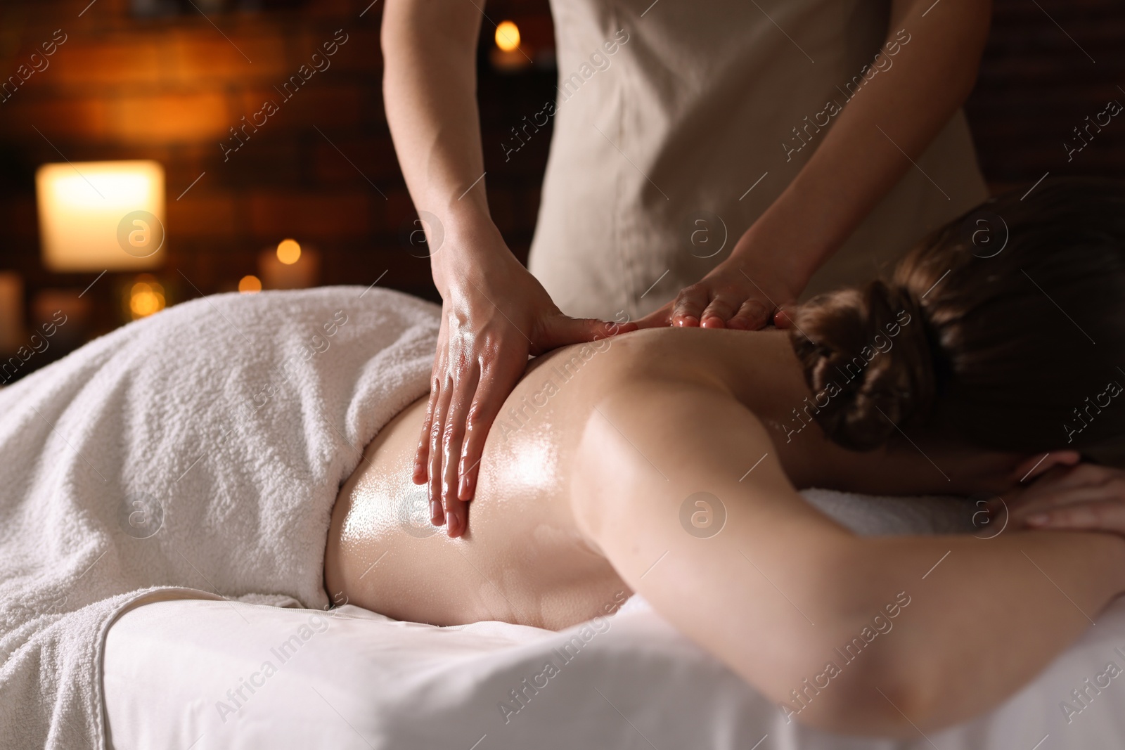 Woman receiving back massage with oil in spa salon, closeup Photo of Woman receiving back massage with oil in spa salon, closeup