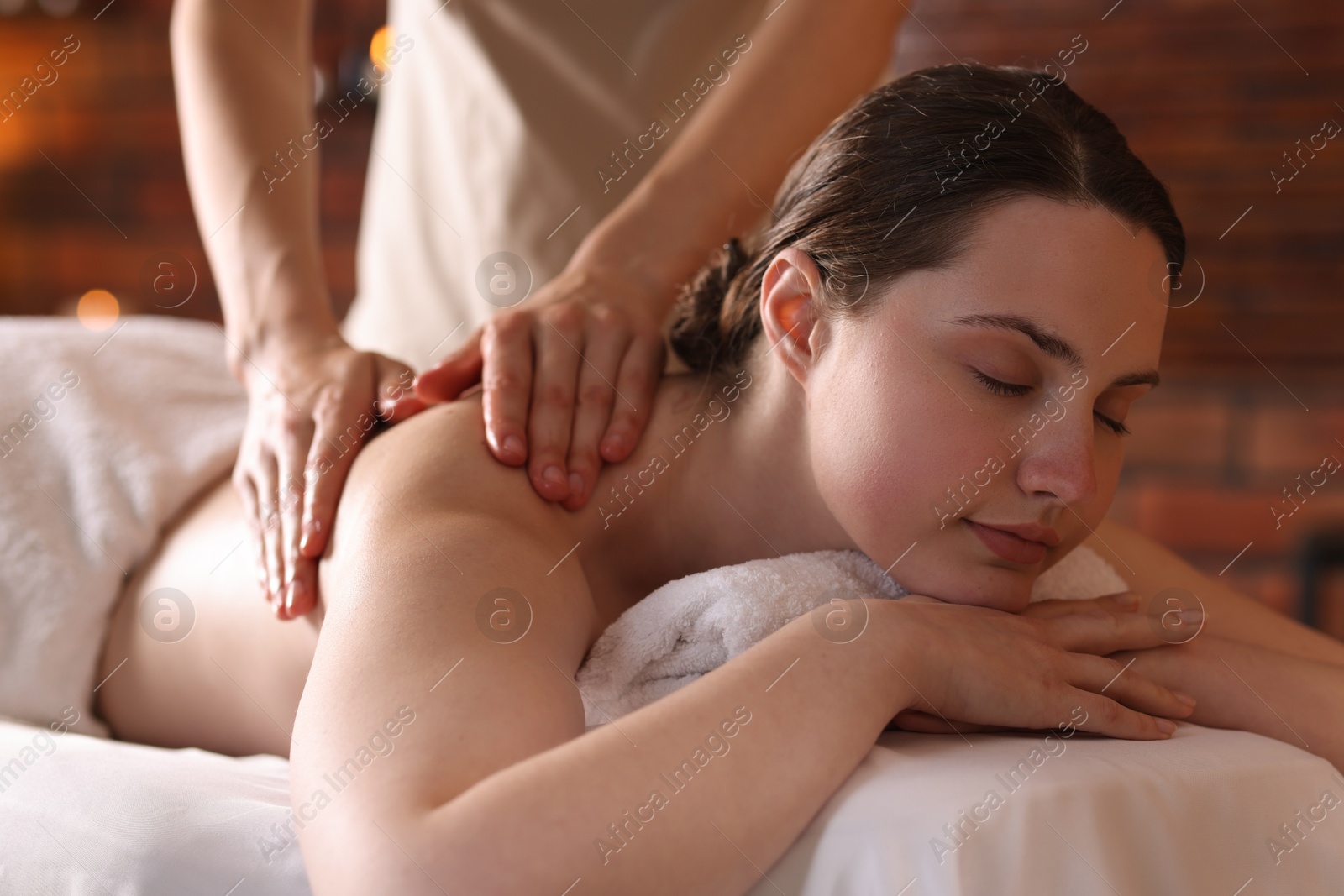 Woman receiving back massage with oil in spa salon Photo of Woman receiving back massage with oil in spa salon
