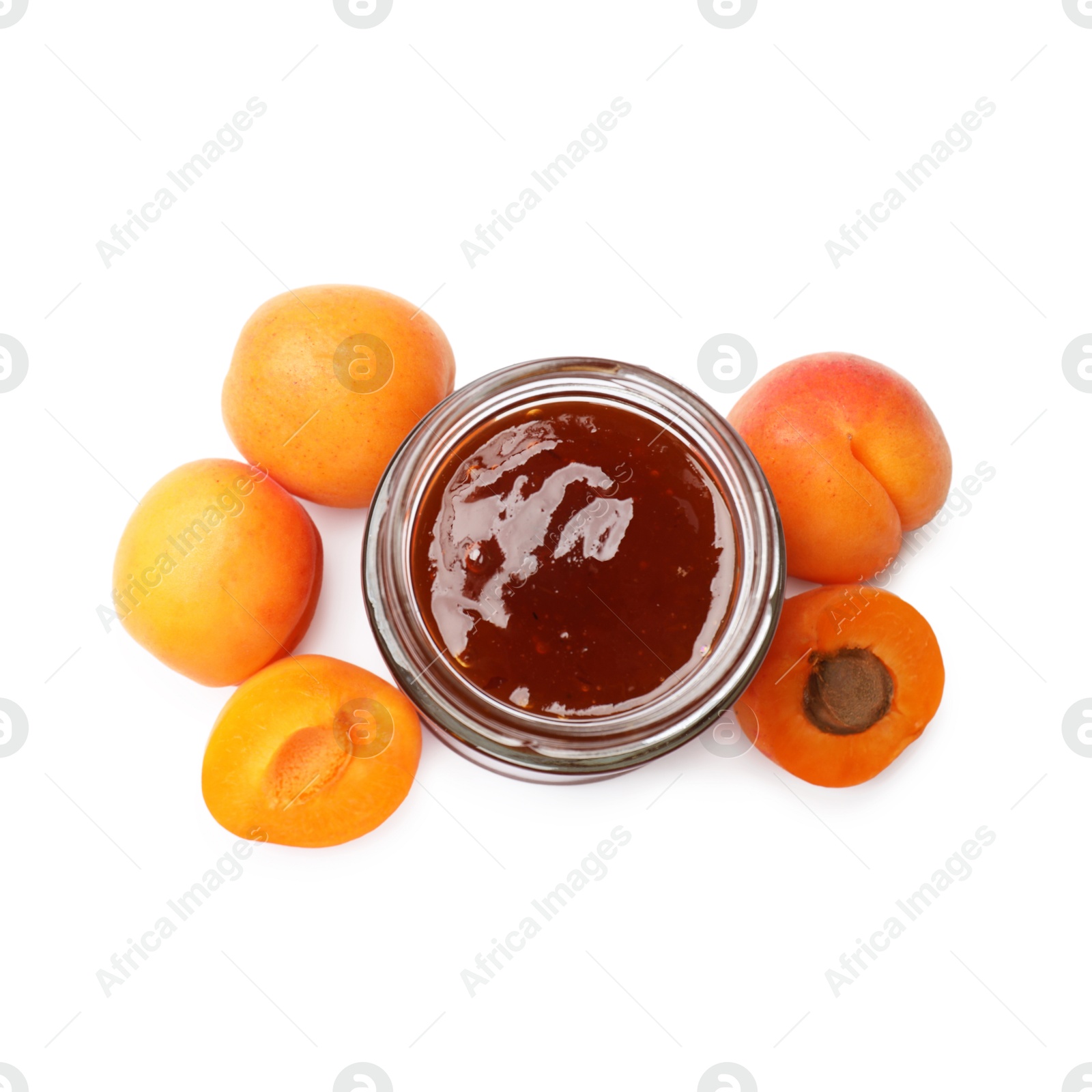 Sweet jam in jar and apricots isolated on white Photo of Sweet jam in jar and apricots isolated on white