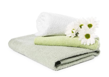 Photo of Soft towels and chrysanthemum flowers isolated on white