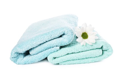 Photo of Soft towels and chrysanthemum flower isolated on white