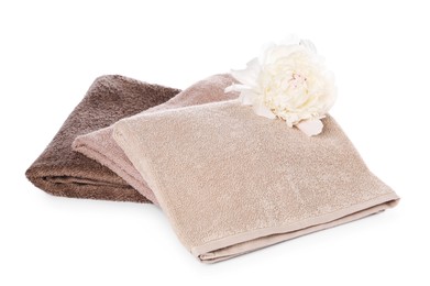 Photo of Soft towels and peony flower isolated on white