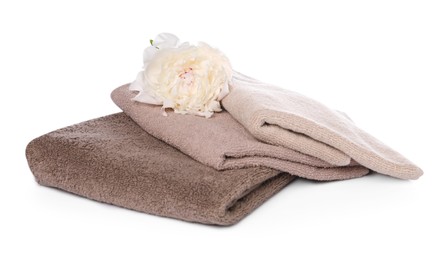 Photo of Soft towels and peony flower isolated on white