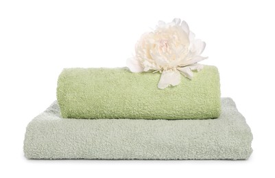 Photo of Soft towels and peony flower isolated on white
