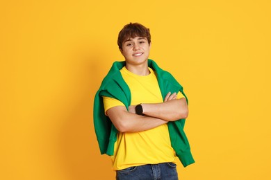 Photo of Portrait of teenage boy on yellow background