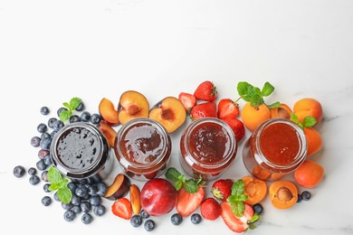 Photo of Different jams in jars and ingredients on white background, flat lay. Space for text