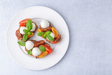 Photo of Tasty sandwiches with mozzarella cheese, tomatoes and basil on white table, top view. Space for text