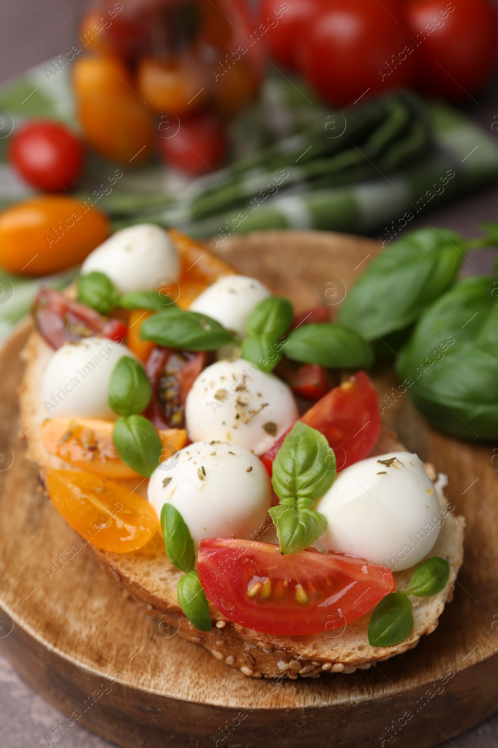 Tasty sandwich with mozzarella cheese, tomatoes and basil on brown table, closeup Photo of Tasty sandwich with mozzarella cheese, tomatoes and basil on brown table, closeup