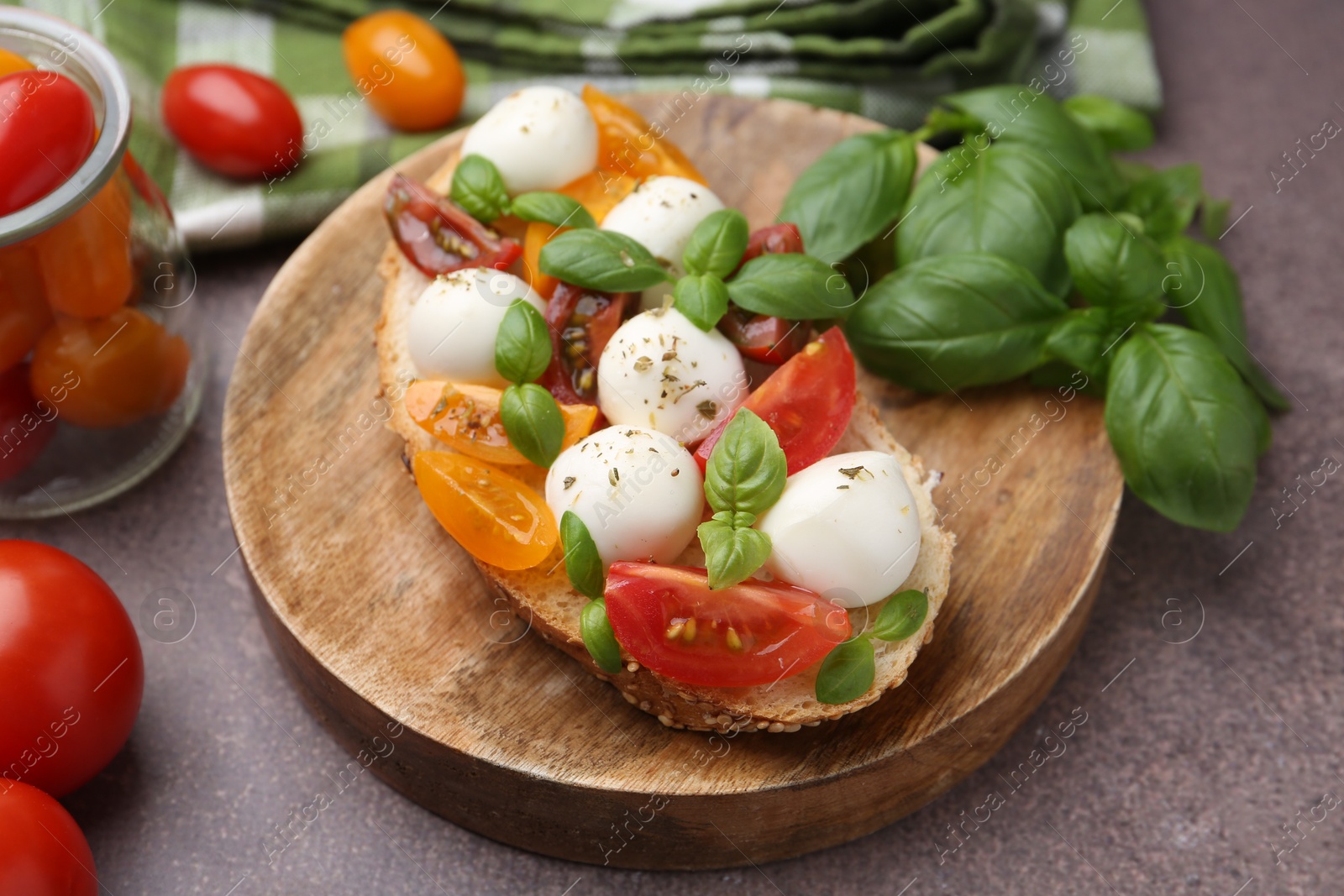 Tasty sandwich with mozzarella cheese, tomatoes and basil on brown table, closeup Photo of Tasty sandwich with mozzarella cheese, tomatoes and basil on brown table, closeup