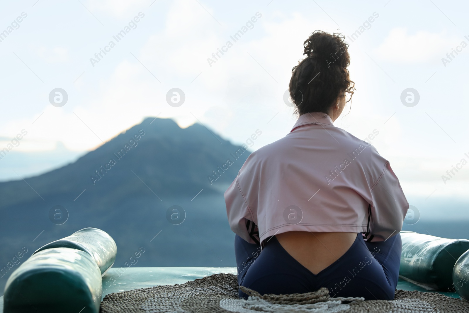 Beautiful woman enjoying picturesque view of mountains, back view. Space for text Photo of Beautiful woman enjoying picturesque view of mountains, back view. Space for text