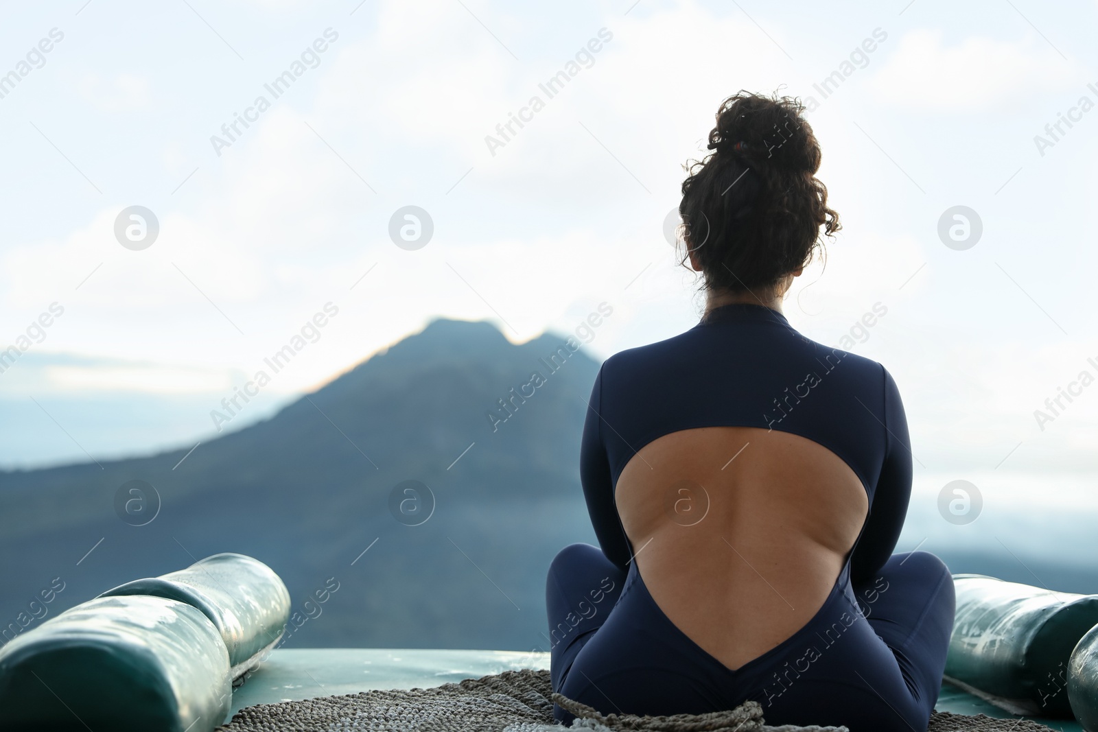 Beautiful woman enjoying picturesque view of mountains, back view. Space for text Photo of Beautiful woman enjoying picturesque view of mountains, back view. Space for text