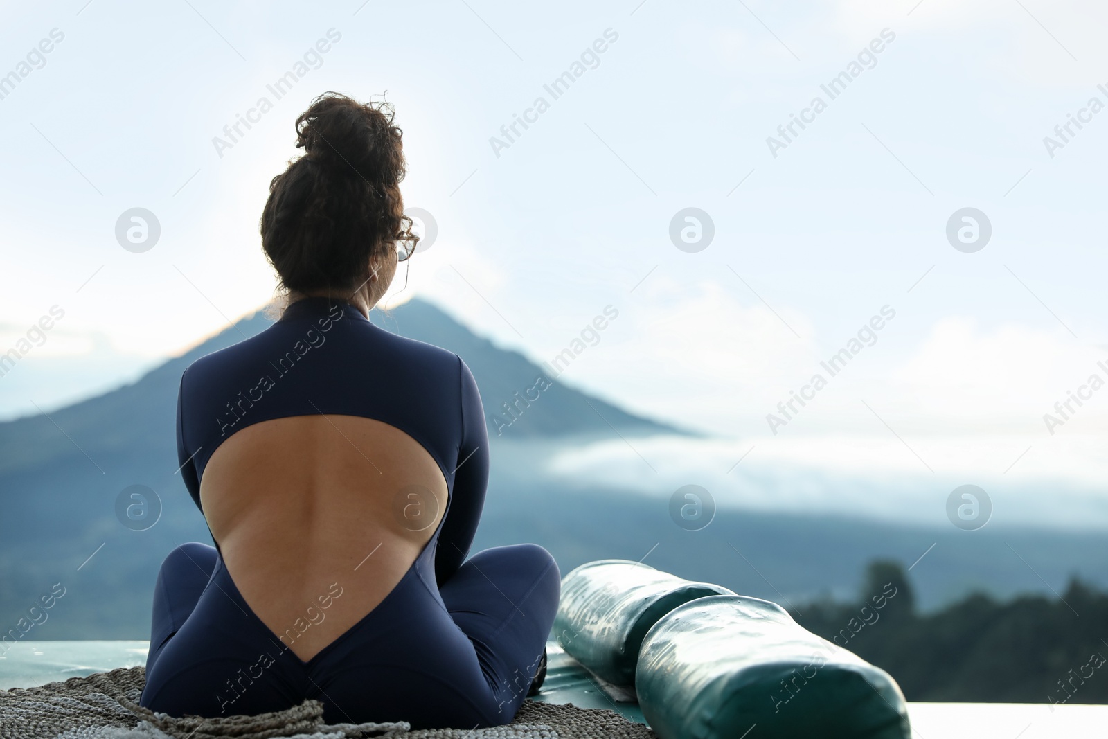 Beautiful woman enjoying picturesque view of mountains, back view. Space for text Photo of Beautiful woman enjoying picturesque view of mountains, back view. Space for text