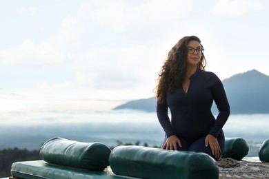 Photo of Beautiful woman enjoying picturesque view of mountains. Space for text