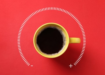 Image of Coffee and power gauge scale on red background, top view. Handle of cup pointing at maximum area. Energizing property of caffeine