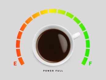 Image of Coffee and power gauge scale on light grey background, top view. Handle of cup pointing at Full area. Energizing property of caffeine