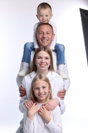 Photo of Family portrait of happy parents and their children on white background