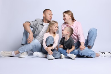 Photo of Full length portrait of happy family on light grey background