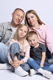 Photo of Happy family posing on light grey background