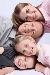 Photo of Happy family posing on light grey background