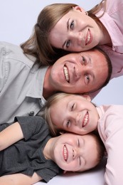 Photo of Happy family posing on light grey background