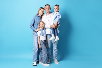 Photo of Full length portrait of happy family on light blue background