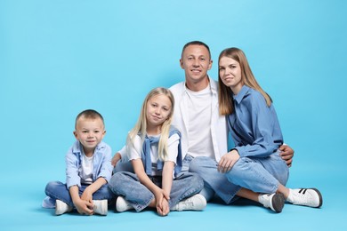 Photo of Full length portrait of happy family on light blue background