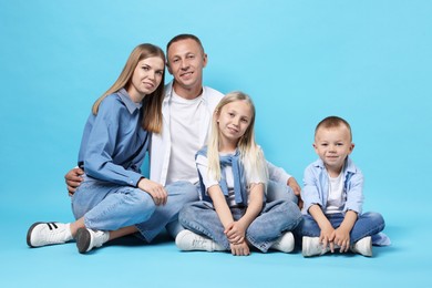 Photo of Full length portrait of happy family on light blue background