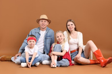 Photo of Full length portrait of happy family on light brown background