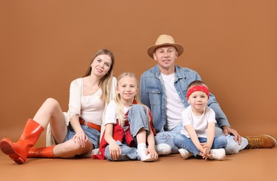 Photo of Full length portrait of happy family on light brown background