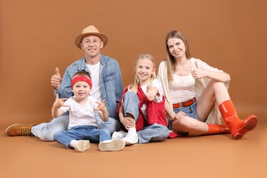 Photo of Full length portrait of happy family gesturing on light brown background