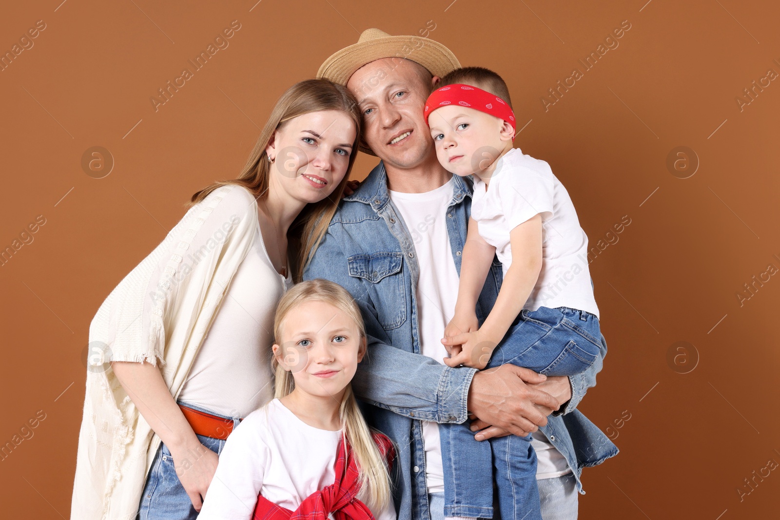 Portrait of happy family on light brown background Photo of Portrait of happy family on light brown background