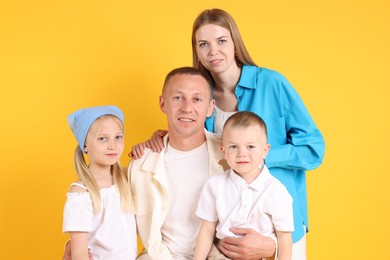 Photo of Family portrait of parents and their children on yellow background