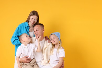 Photo of Happy family on yellow background. Space for text