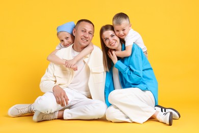 Photo of Full length portrait of happy family on yellow background