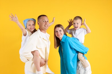 Photo of Family portrait of parents and their children on yellow background