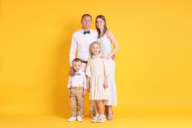 Photo of Full length portrait of happy family on yellow background